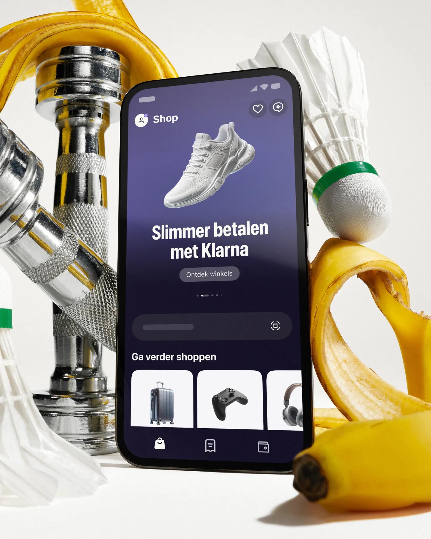 Phone with klarna app in front of artistically styled sport atributes