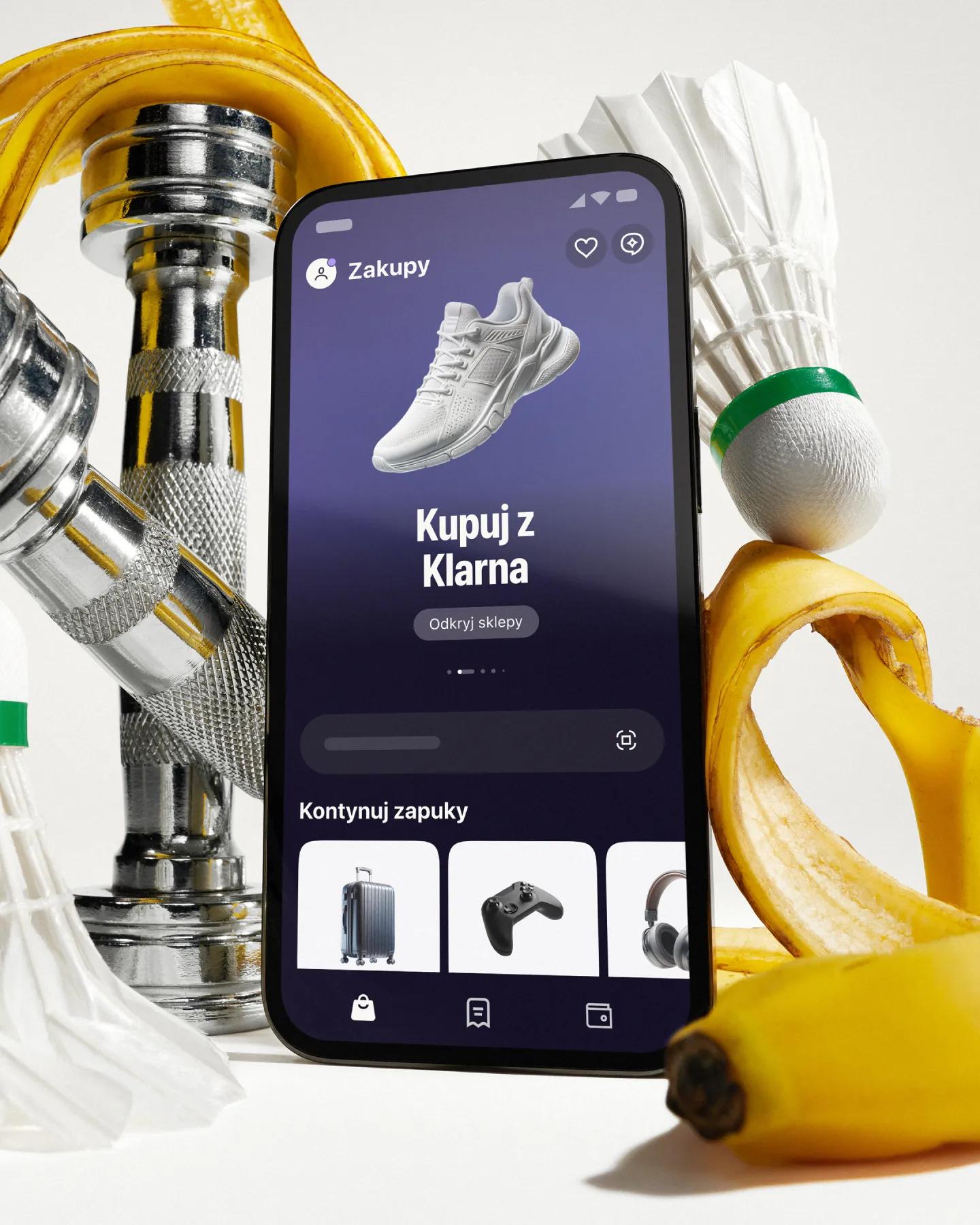 Phone with klarna app in front of artistically styled sport atributes